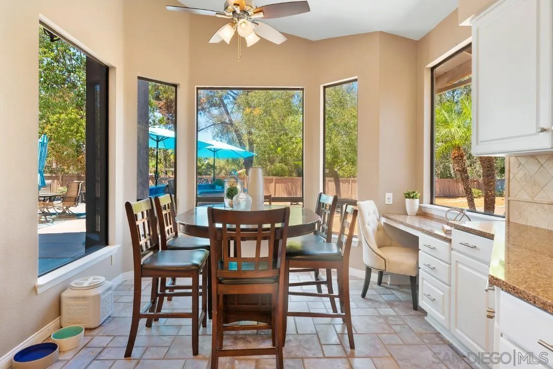 15735 Riparian Road Poway, CA 92064 - Photo 15 of 53 a view of a dining room with furniture a chandelier and wooden floor