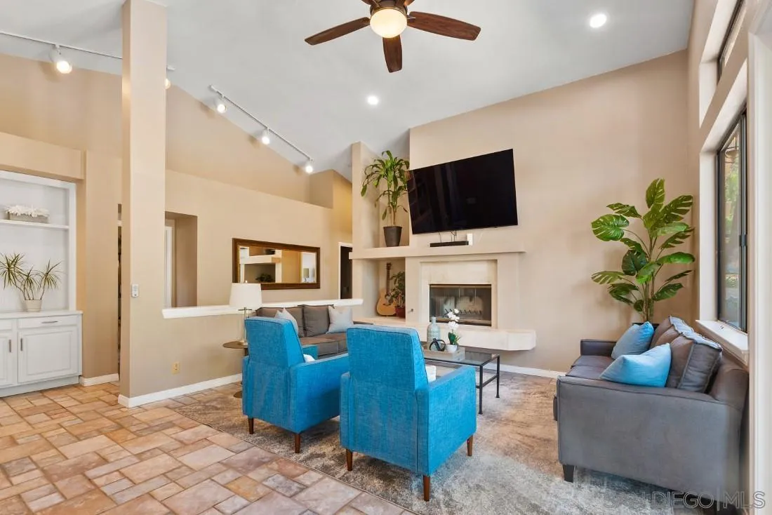 15735 Riparian Road Poway, CA 92064 - Photo 16 of 53 a living room with furniture a fireplace and a flat screen tv