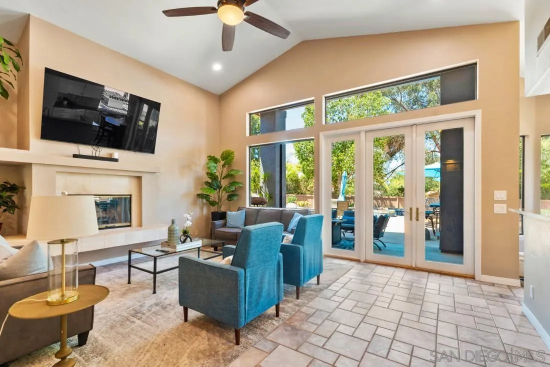 15735 Riparian Road Poway, CA 92064 - Photo 18 of 53 a living room with furniture a flat screen tv and a fireplace