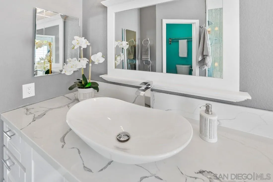 15735 Riparian Road Poway, CA 92064 - Photo 26 of 53 a bathroom with a sink and mirror