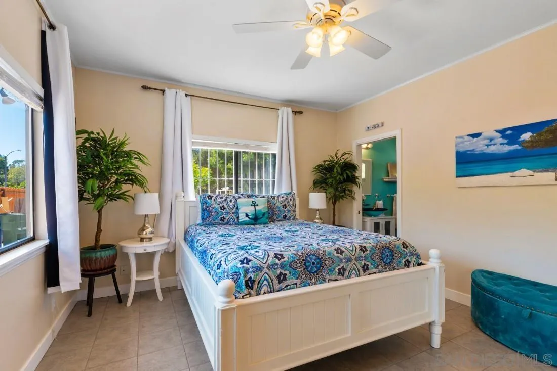 15735 Riparian Road Poway, CA 92064 - Photo 27 of 53 a bedroom with a bed and a chandelier