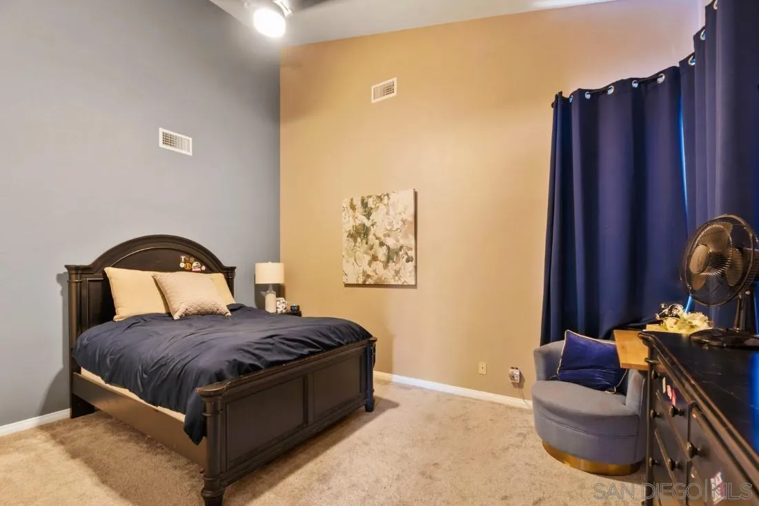 15735 Riparian Road Poway, CA 92064 - Photo 30 of 53 a bedroom with a bed and wooden floor