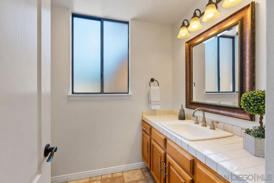 15735 Riparian Road Poway, CA 92064 - Photo 32 of 53 a bathroom with a sink and a mirror