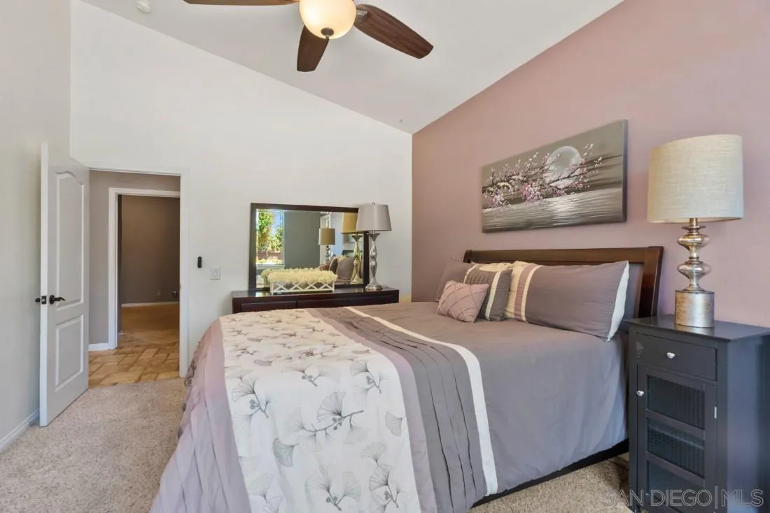 15735 Riparian Road Poway, CA 92064 - Photo 34 of 53 a bedroom with a large bed and a chandelier