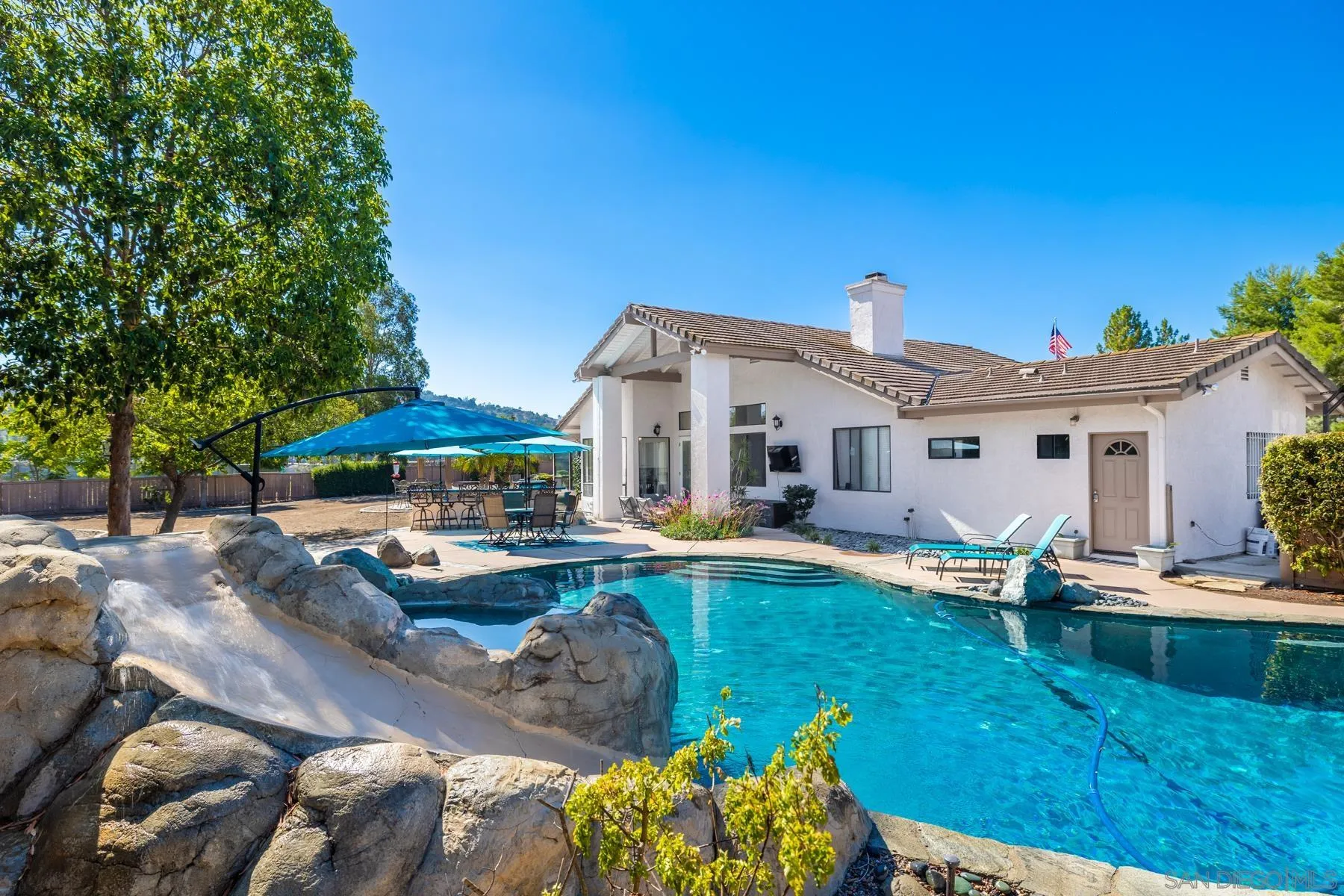 15735 Riparian Road Poway, CA 92064 - Photo 41 of 53 a view of a house with backyard sitting area and swimming pool