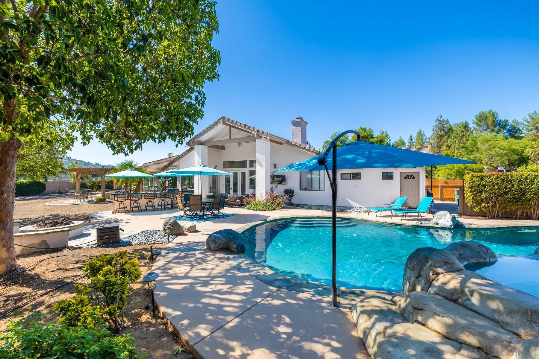 15735 Riparian Road Poway, CA 92064 - Photo 43 of 53 a view of a house with backyard porch and sitting area