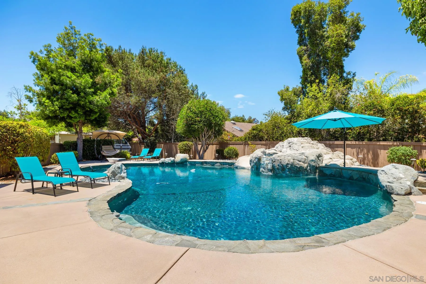 15735 Riparian Road Poway, CA 92064 - Photo 45 of 53 a view of a swimming pool with a patio