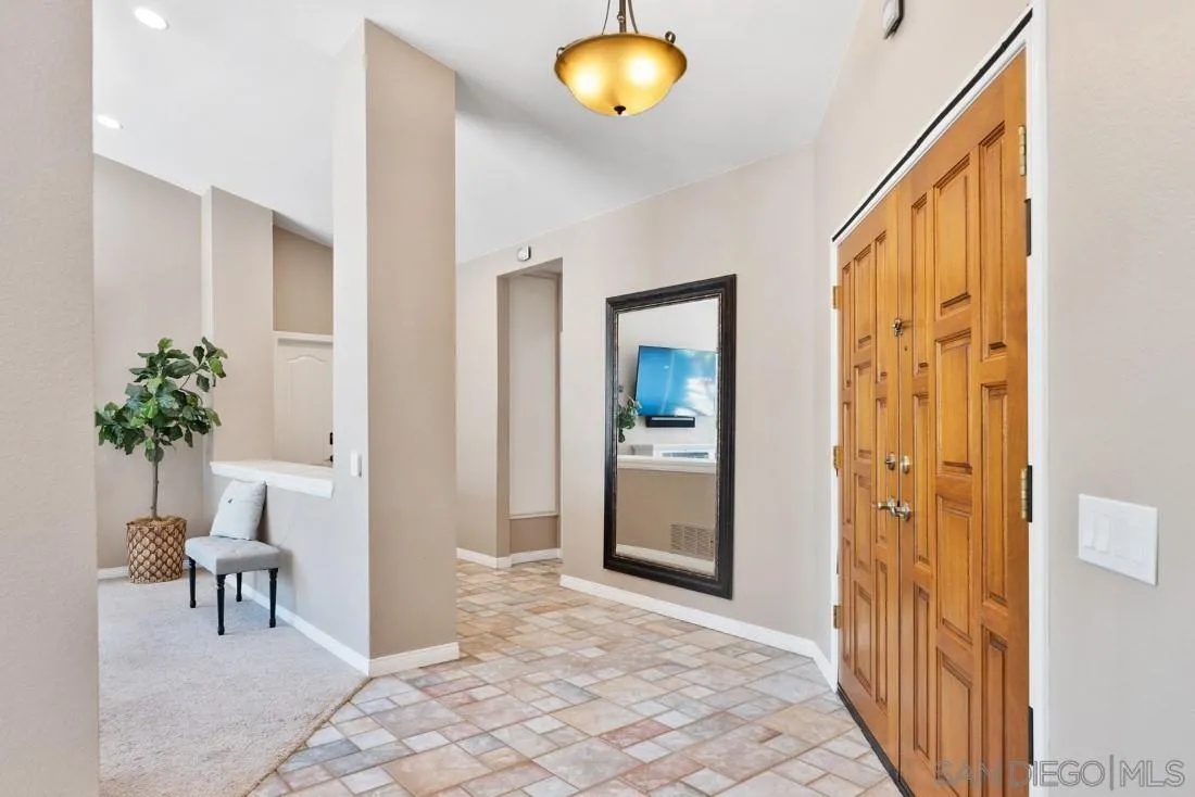15735 Riparian Road Poway, CA 92064 - Photo 8 of 53 a view of a hallway to a livingroom with furniture and a window