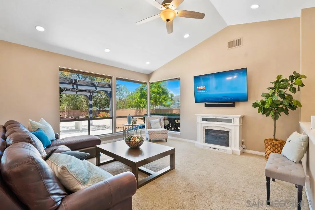 15735 Riparian Road Poway, CA 92064 - Photo 9 of 53 a living room with furniture fireplace and flat screen tv