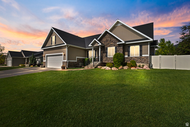 580 Cherry Ridge Lane Richmond, UT 84333 - Photo 49 of 53 Craftsman-style home featuring stone siding, concrete driveway, board and batten siding, and a gate