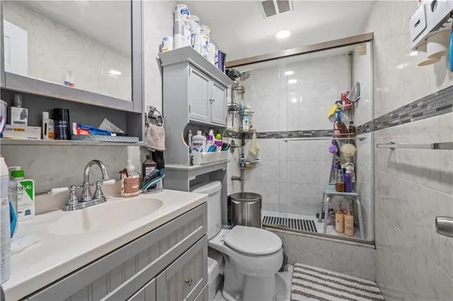 a bathroom with a sink a toilet and a mirror