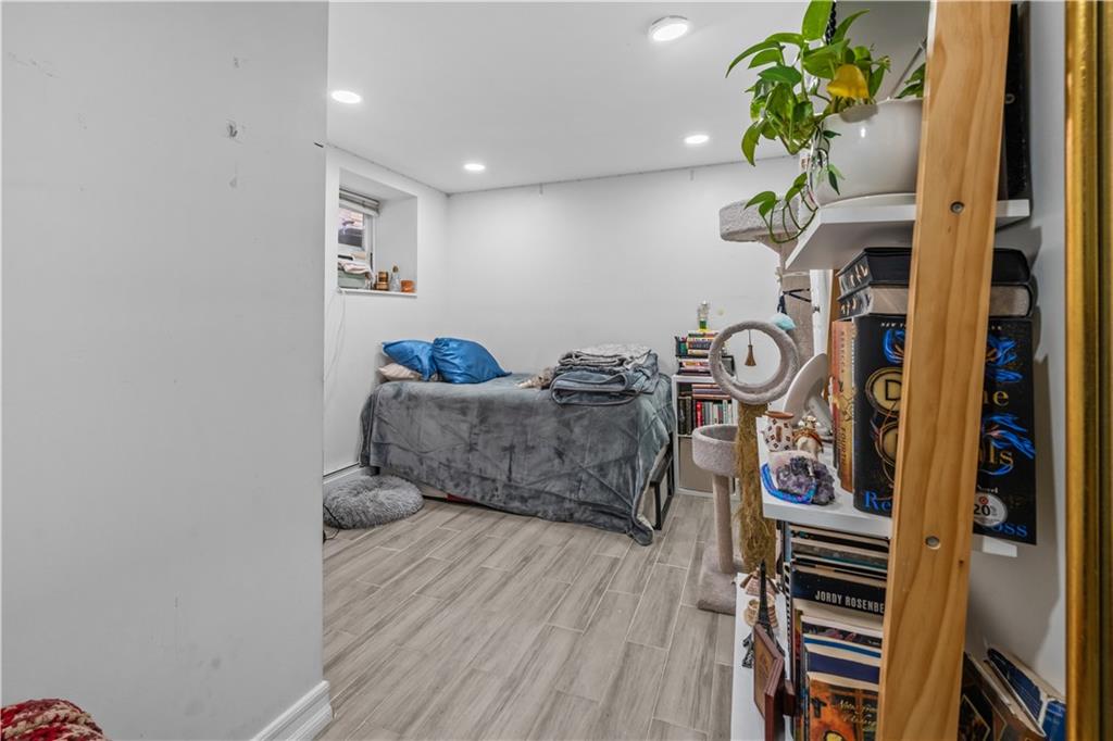 904 Avenue C Brooklyn, NY 11218 - Photo 10 of 13 a living room with furniture and a potted plant