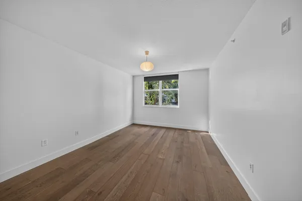 a view of a brick wall with a chair in the patio