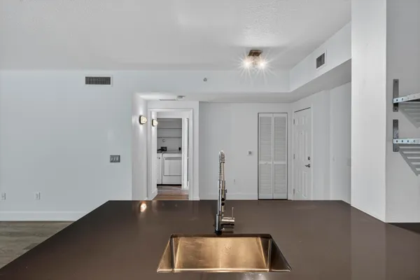 a bathroom with a toilet a sink a mirror and shower