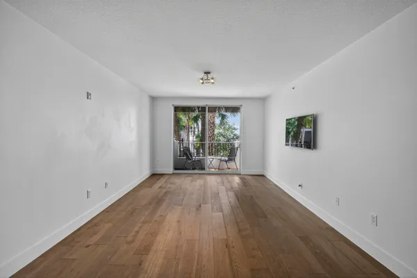 a kitchen with stainless steel appliances a refrigerator a stove and white cabinets