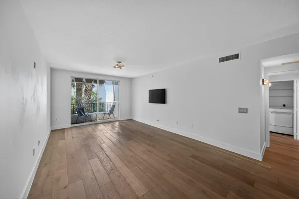 a view of a kitchen with a sink and a refrigerator