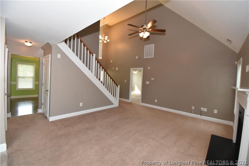 131 South Prince Henry Way Cameron, NC 28326 - Photo 3 of 26 a view of an empty room with stairs and a chandelier fan