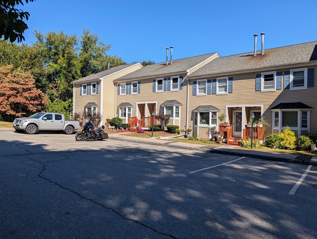 a front view of a residential apartment building with yard