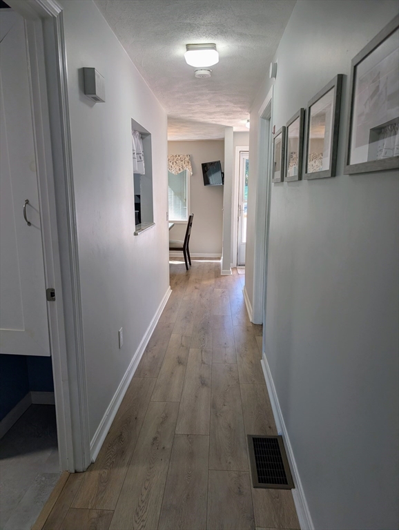 24 Charles Street, Unit 10 Douglas, MA 01516 - Photo 11 of 35 a view of hallway with wooden floor