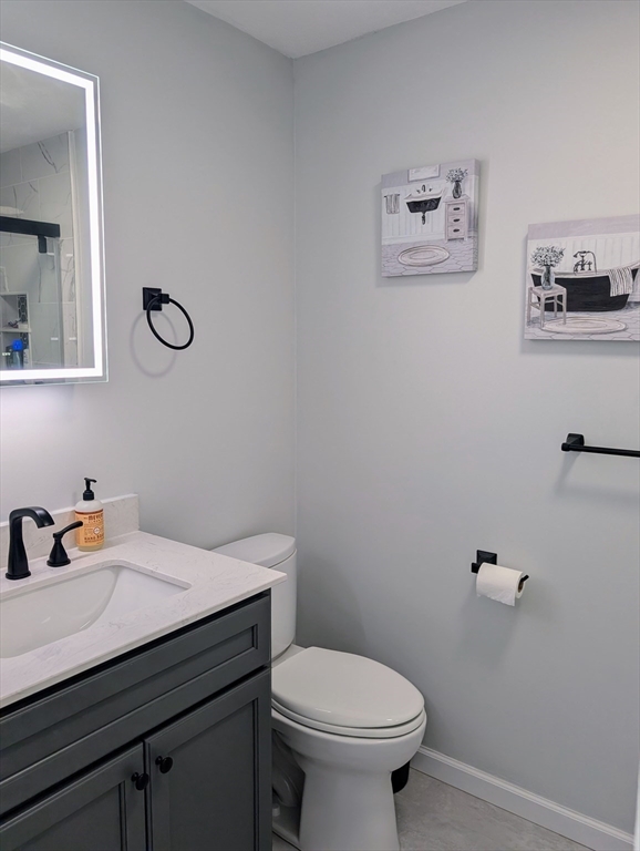 24 Charles Street, Unit 10 Douglas, MA 01516 - Photo 19 of 35 a bathroom with a sink mirror vanity and toilet