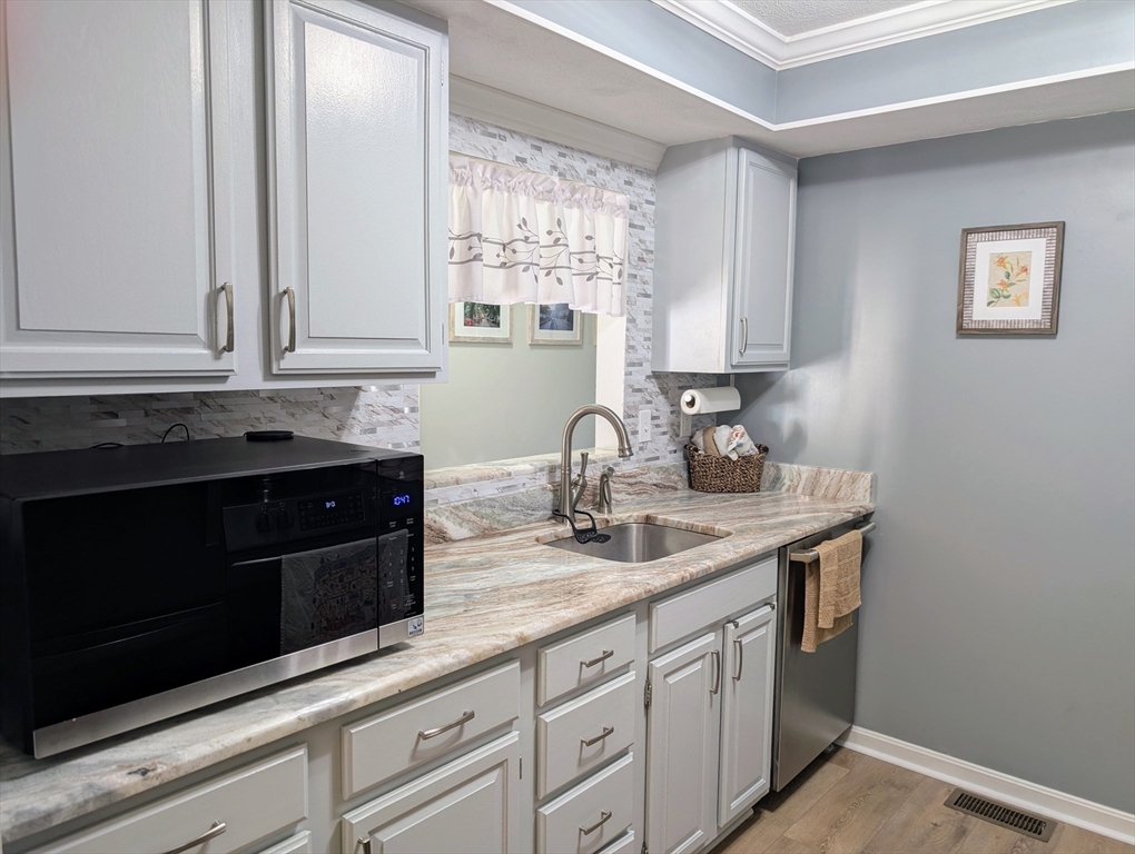 24 Charles Street, Unit 10 Douglas, MA 01516 - Photo 2 of 35 a kitchen with stainless steel appliances granite countertop white cabinets and a granite counter tops
