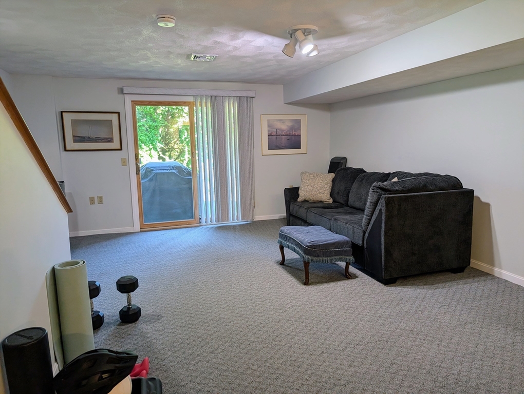 24 Charles Street, Unit 10 Douglas, MA 01516 - Photo 22 of 35 a living room with furniture and a window