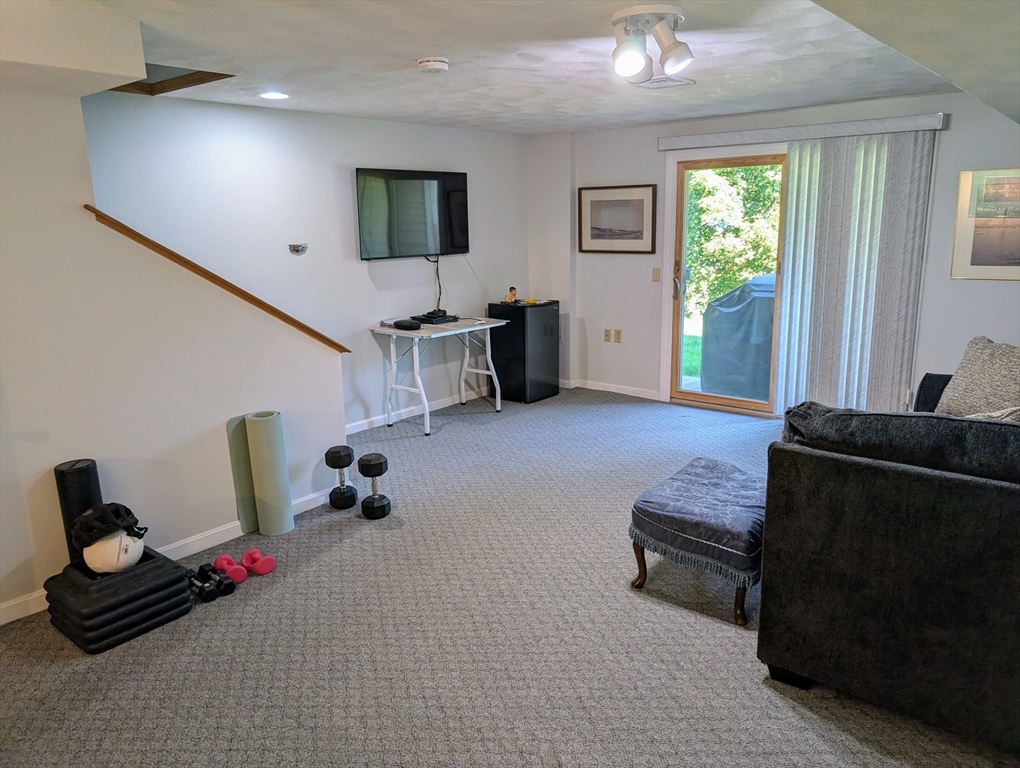 24 Charles Street, Unit 10 Douglas, MA 01516 - Photo 23 of 35 a living room with furniture and a flat screen tv