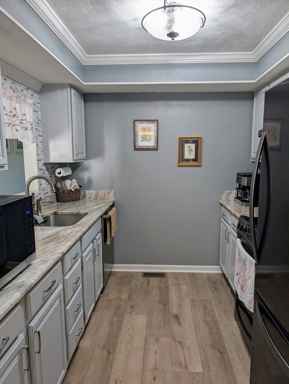 24 Charles Street, Unit 10 Douglas, MA 01516 - Photo 3 of 35 a kitchen with stainless steel appliances granite countertop a sink stove and refrigerator