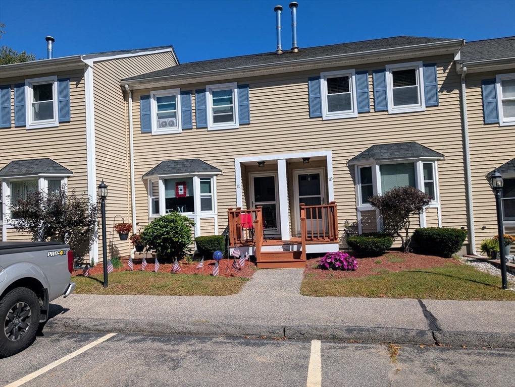 24 Charles Street, Unit 10 Douglas, MA 01516 - Photo 34 of 35 a front view of a house with a yard