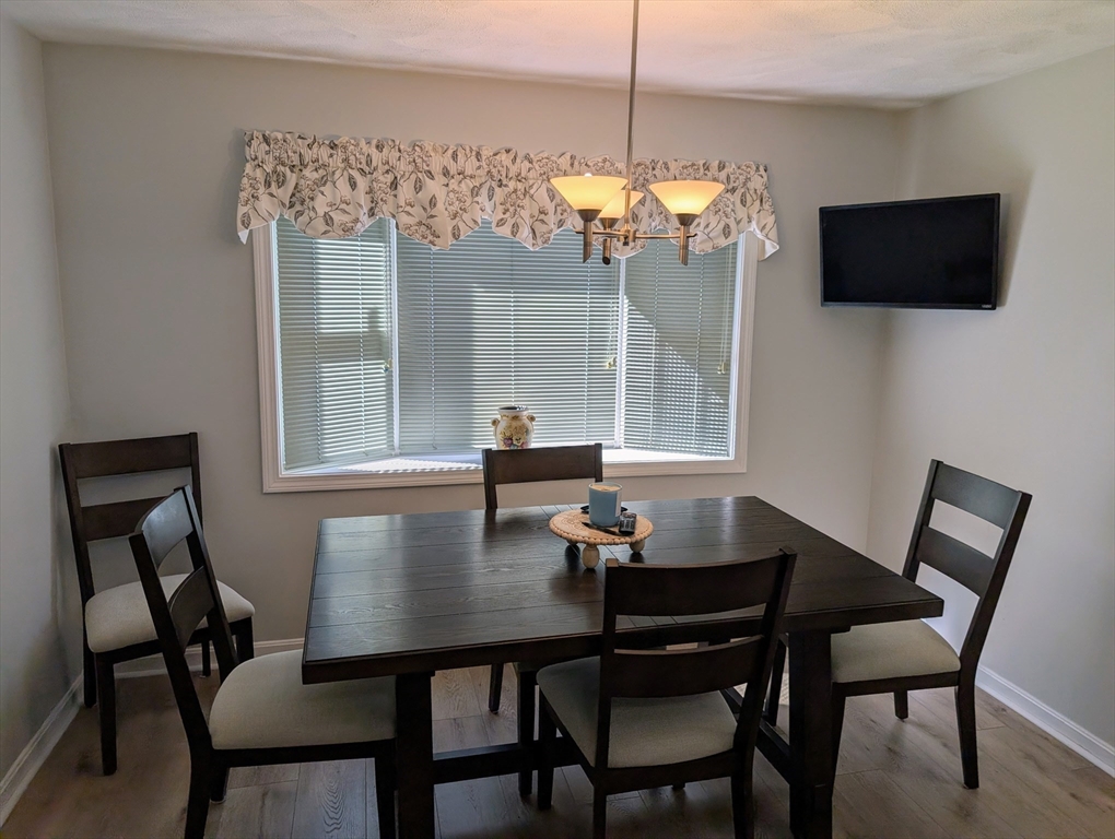 24 Charles Street, Unit 10 Douglas, MA 01516 - Photo 5 of 35 a view of a dining room with furniture window and wooden floor