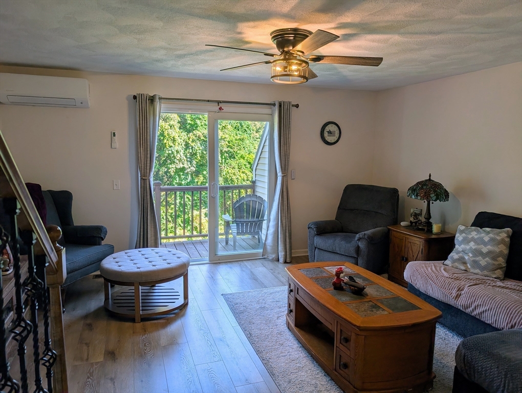 24 Charles Street, Unit 10 Douglas, MA 01516 - Photo 8 of 35 a living room with furniture and a large window