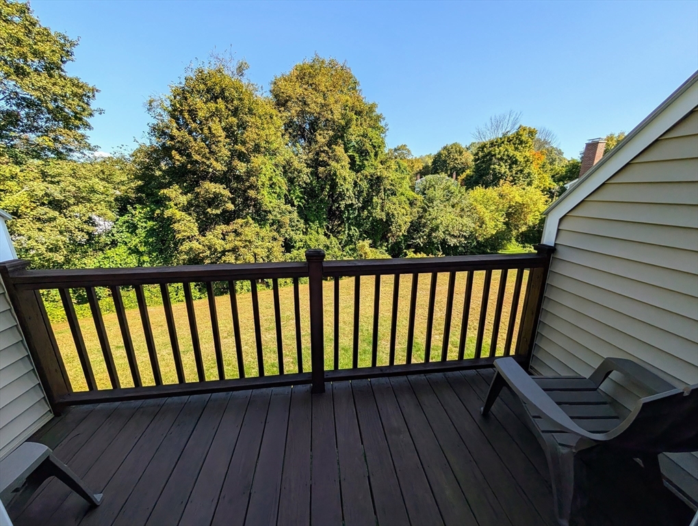 24 Charles Street, Unit 10 Douglas, MA 01516 - Photo 10 of 35 a balcony with wooden floor