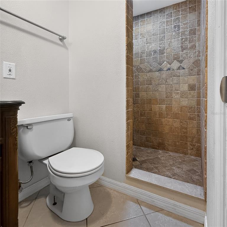 17220 Estes Road Lutz, FL 33548 - Photo 15 of 25 a bathroom with a toilet and a shower