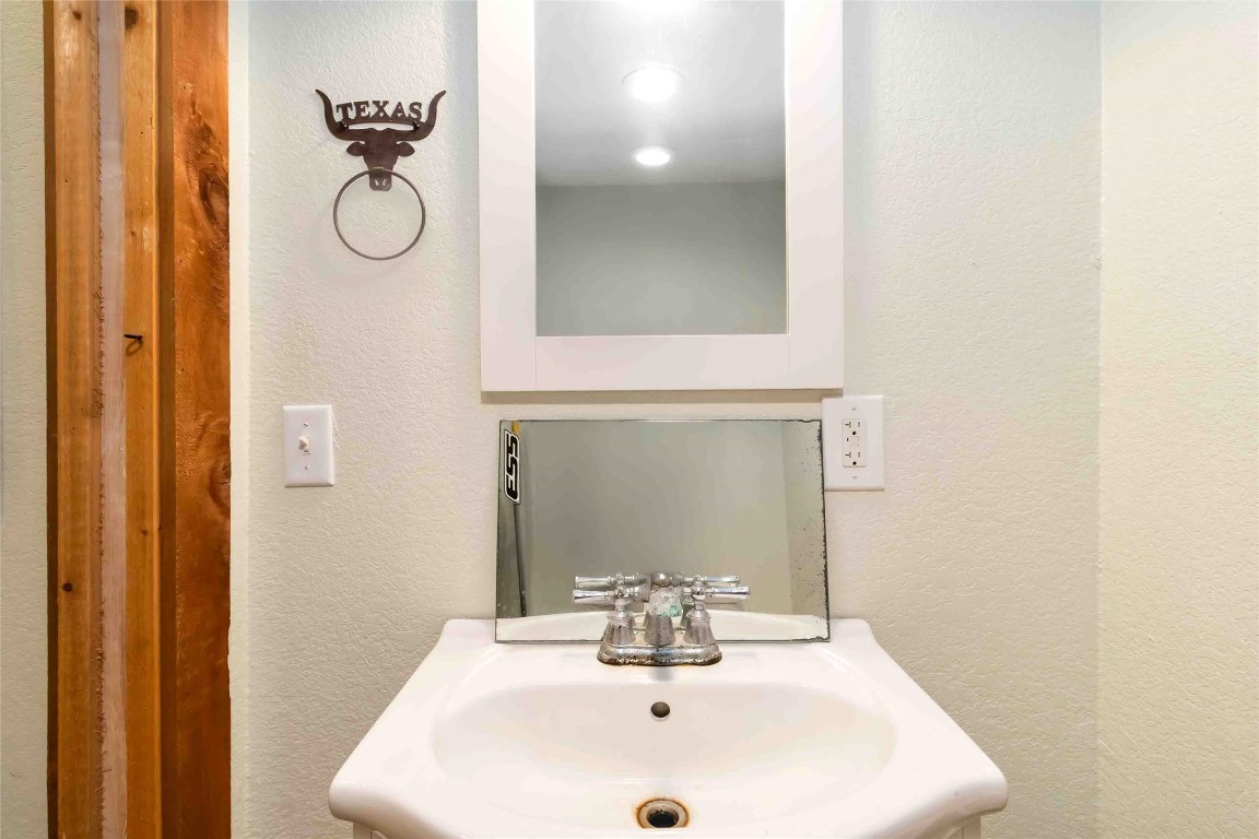 227 Henderson Lane Lockhart, TX 78644 - Photo 18 of 38 a bathroom with a sink and a mirror