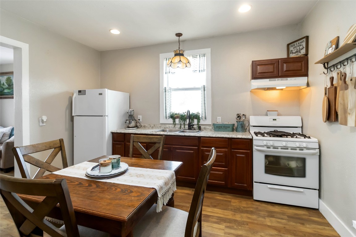 227 Henderson Lane Lockhart, TX 78644 - Photo 24 of 38 a kitchen with granite countertop a sink dining table and chairs