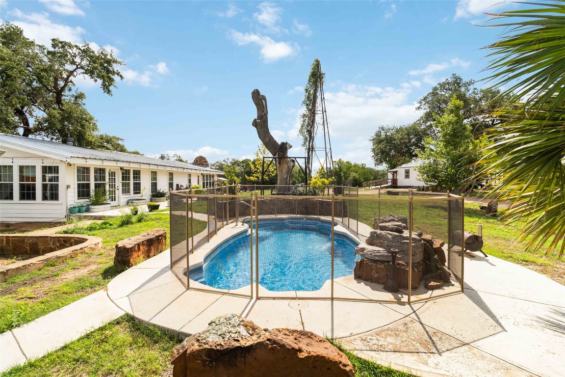 227 Henderson Lane Lockhart, TX 78644 - Photo 4 of 38 a view of a swimming pool with a chair and tables