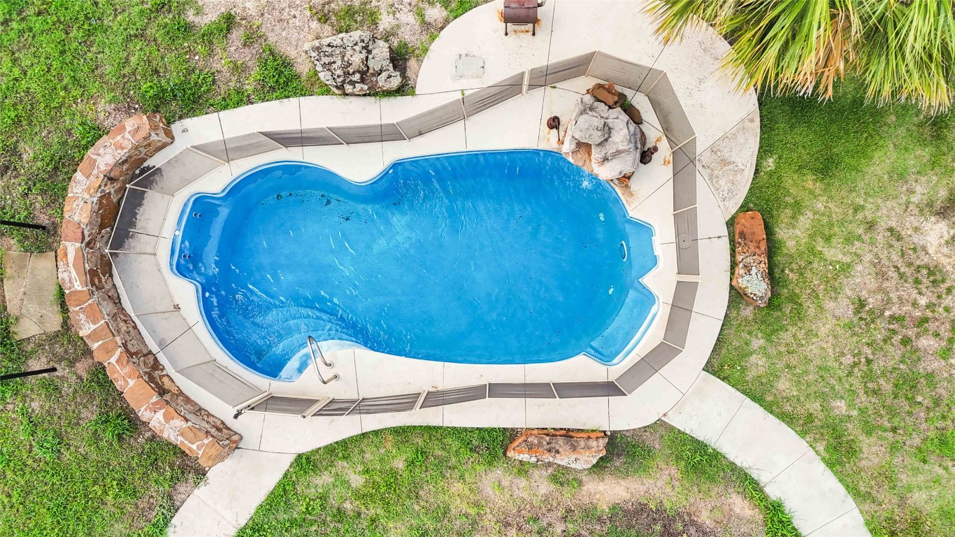 227 Henderson Lane Lockhart, TX 78644 - Photo 5 of 38 a view of a swimming pool with a yard