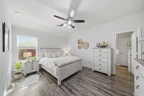 a living room with furniture a flat screen tv and kitchen view