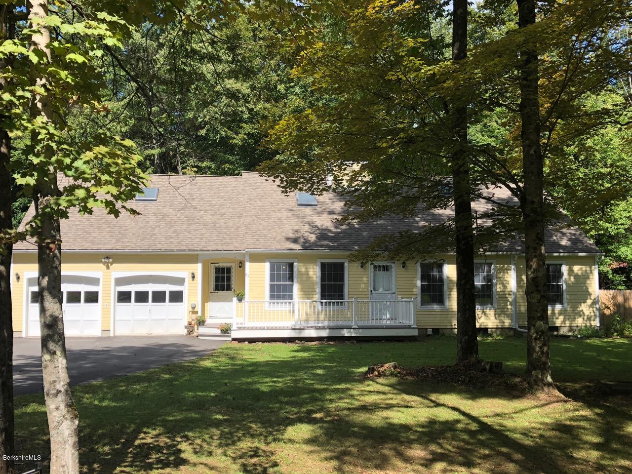 83 Pine Knoll Road Lenox, MA 01240 - Photo 1 of 32 a front view of a house with a garden