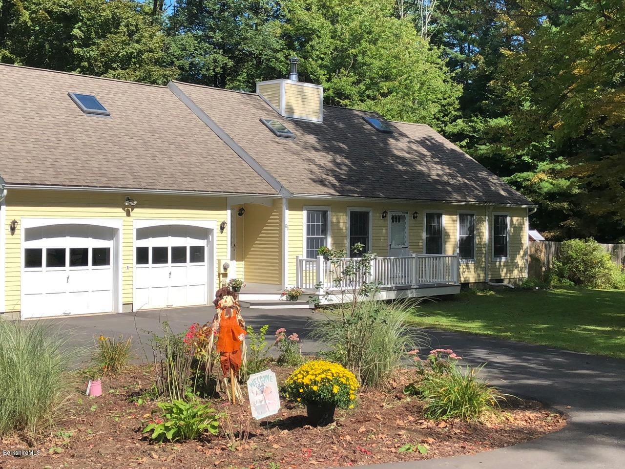 83 Pine Knoll Road Lenox, MA 01240 - Photo 2 of 32 a front view of a house with a garden and trees