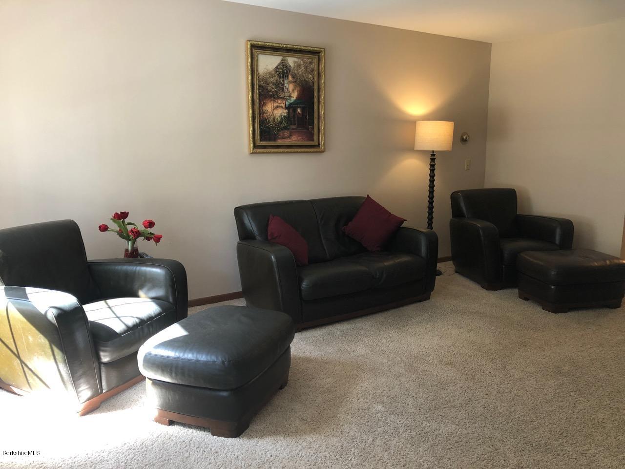 83 Pine Knoll Road Lenox, MA 01240 - Photo 18 of 32 a living room with furniture and a lamp