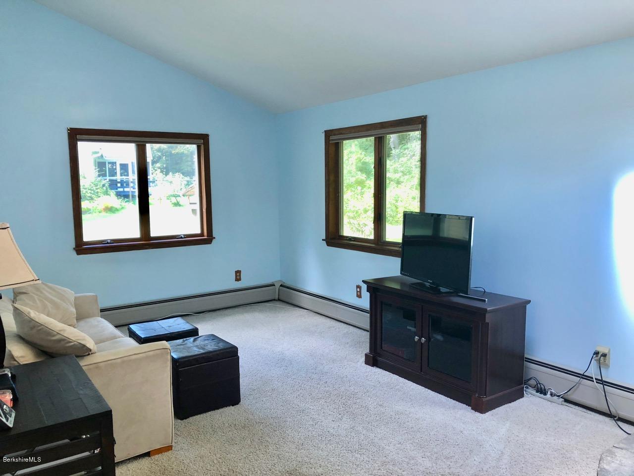 83 Pine Knoll Road Lenox, MA 01240 - Photo 20 of 32 a living room with furniture and a flat screen tv