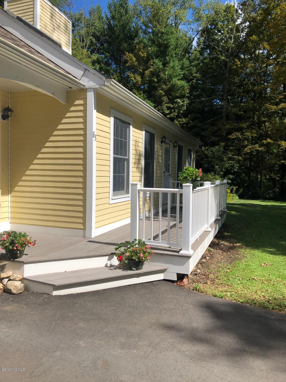 83 Pine Knoll Road Lenox, MA 01240 - Photo 3 of 32 a front view of a house with a yard