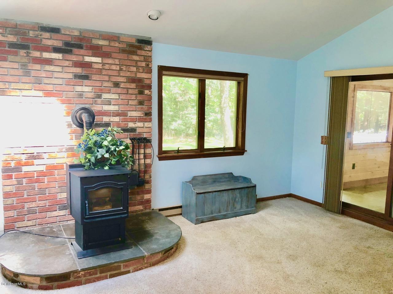 83 Pine Knoll Road Lenox, MA 01240 - Photo 21 of 32 a view of a livingroom with furniture and a fireplace