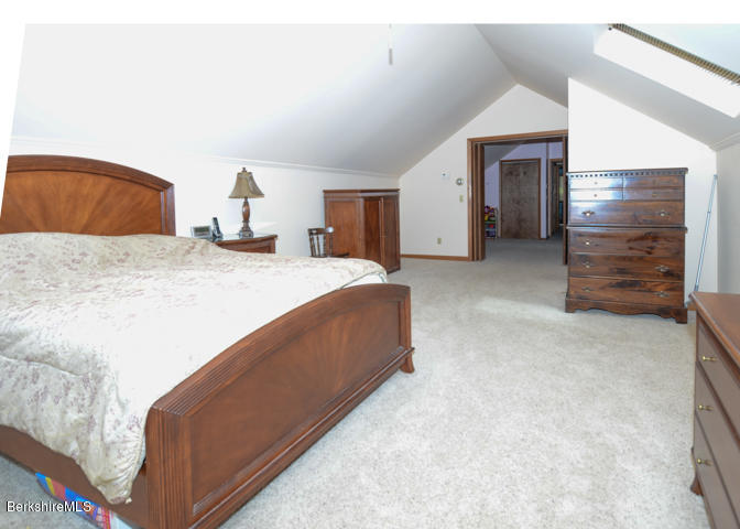 83 Pine Knoll Road Lenox, MA 01240 - Photo 24 of 32 a bed room with a bed and a television