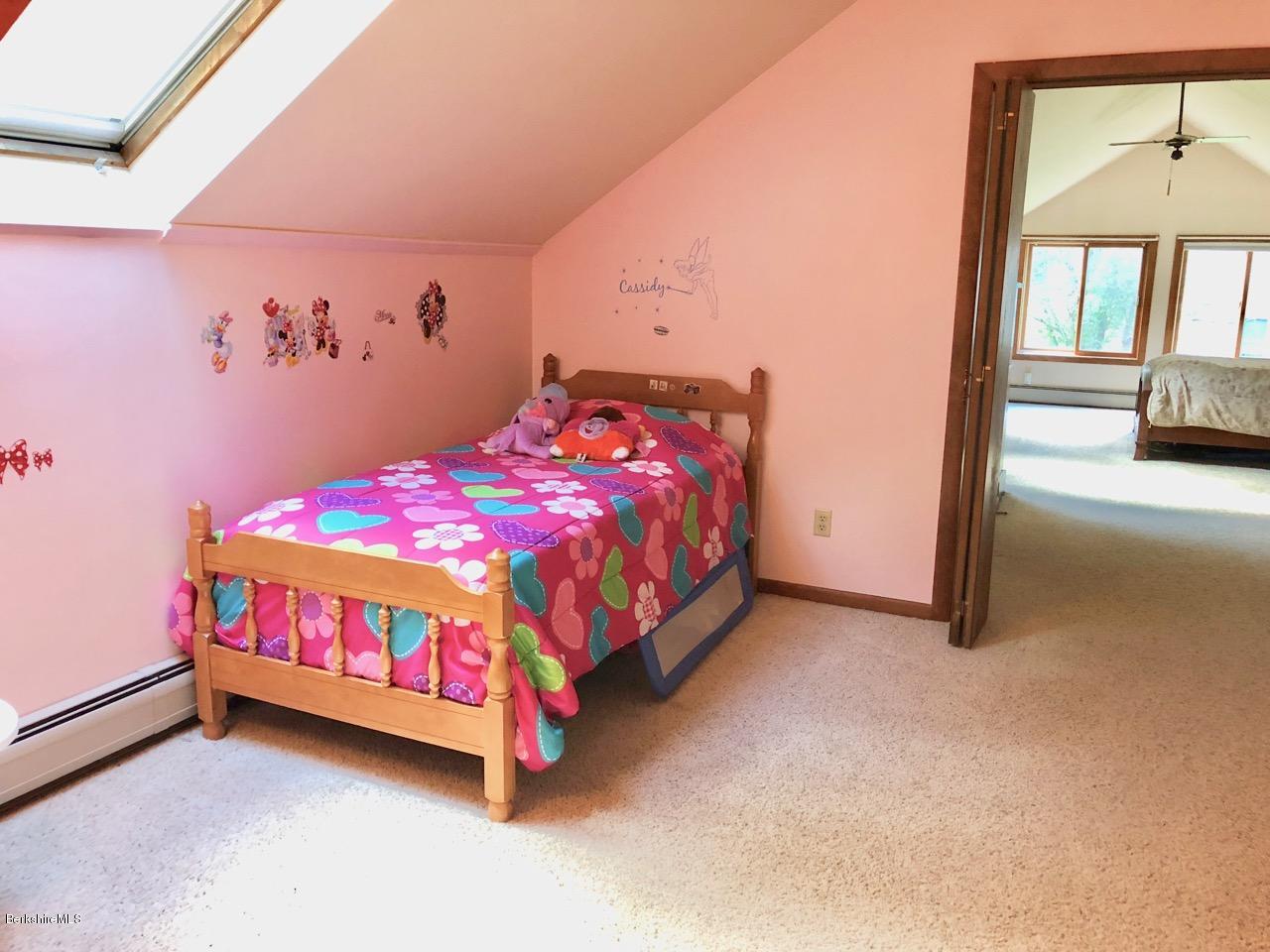 83 Pine Knoll Road Lenox, MA 01240 - Photo 30 of 32 a bedroom with a bed and a mirror