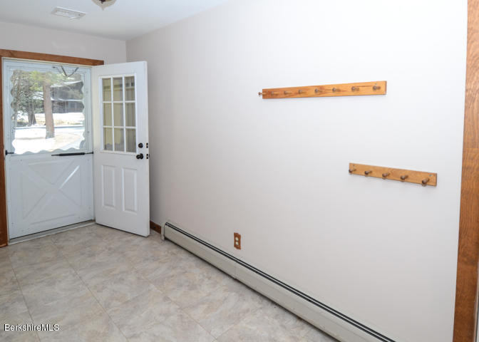 83 Pine Knoll Road Lenox, MA 01240 - Photo 9 of 32 an empty room with an entryway
