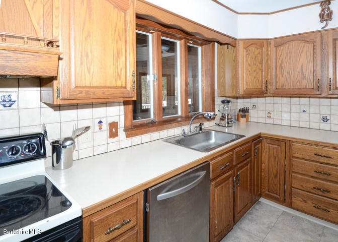 83 Pine Knoll Road Lenox, MA 01240 - Photo 10 of 32 a kitchen with a sink and a stove
