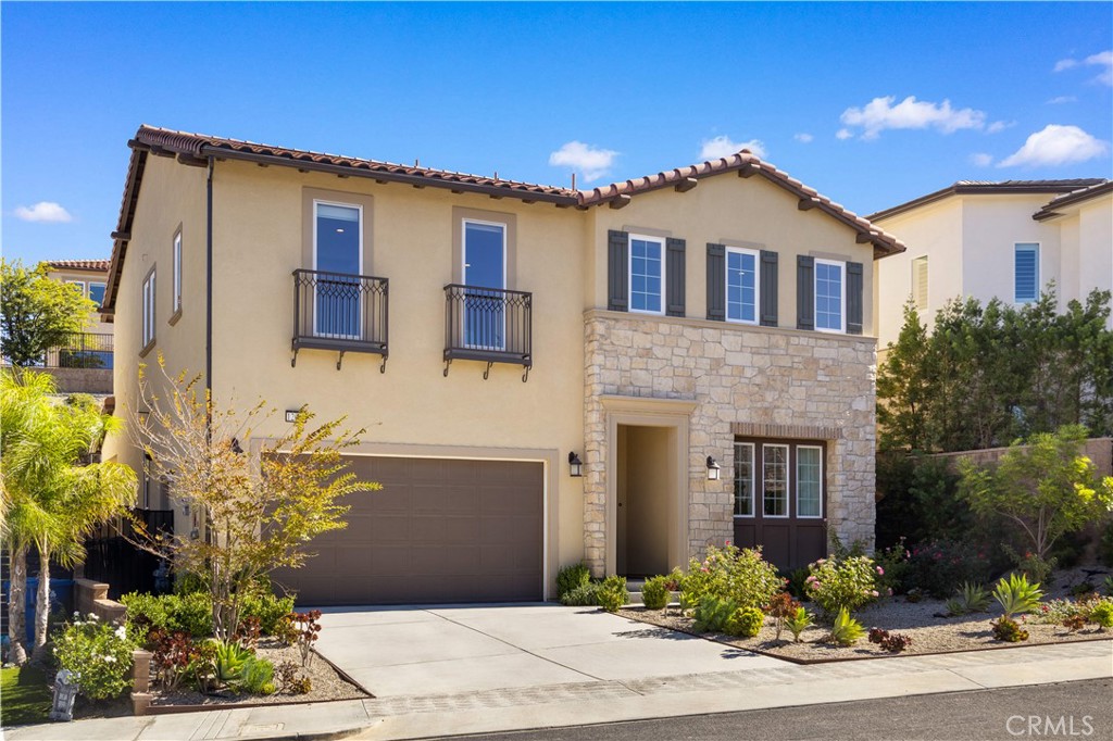 12000 Mirabel Way Porter Ranch, CA 91326 - Photo 3 of 59 a front view of a house with a yard