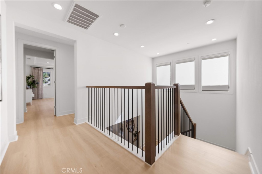 12000 Mirabel Way Porter Ranch, CA 91326 - Photo 33 of 59 a view of a hallway with wooden floor and windows